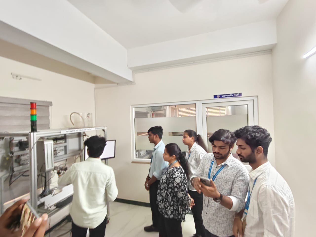 Students at the automatic bottle-filling rig on the Infercon lab floor
